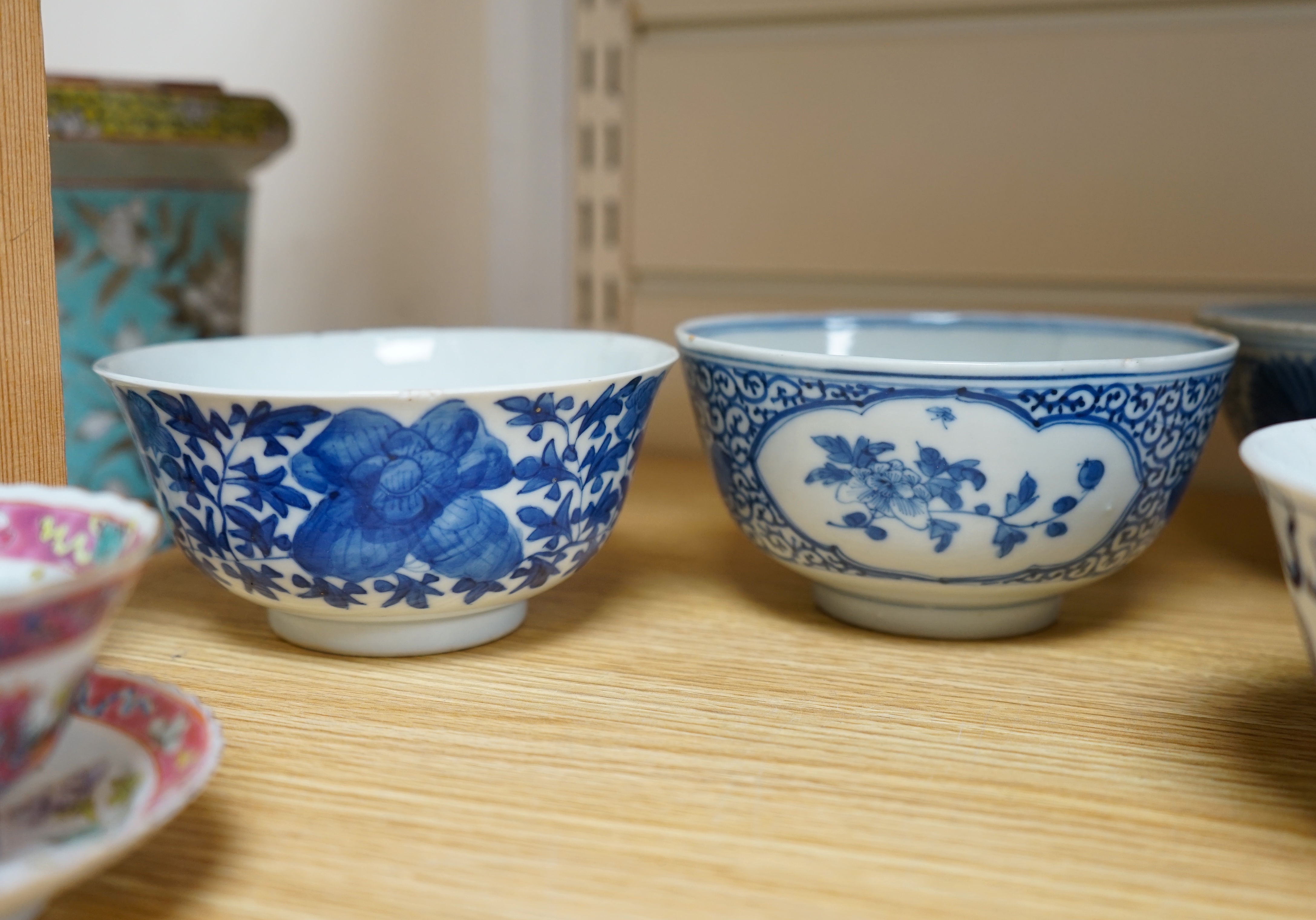 A quantity of Chinese and Japanese porcelain to include blue and white bowls, famille rose tea bowls and a pair of late 19th century dishes (18). Condition - varies, poor to fair